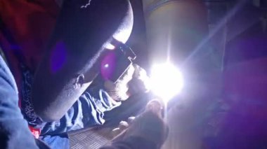 Professional Welder Wears Helmet Working in Heavy Industry Process Pipe, Welding Piping Construction of the Oil, Natural Gas and Fuels Transport Pipeline. Industrial Manufacturing Factory.