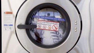 Washing machines with dirty laundry, public coin laundry, Self-service laundromat, laundrette.