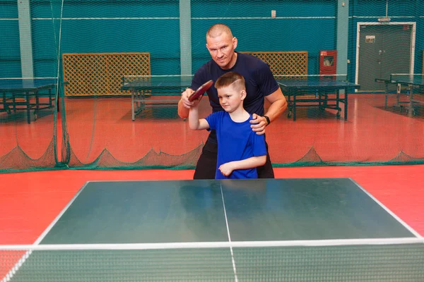 the coach teaches the Igart and table tennis. practice of the blow in table tennis