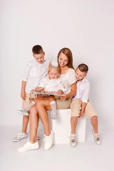 Lycklig Mor Och Tre Barn Läser Bok Tillsammans Vit Bakgrund — Stockfoto