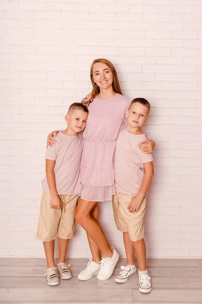Happy Mother Hugs Two Sons Indoors — Stockfoto