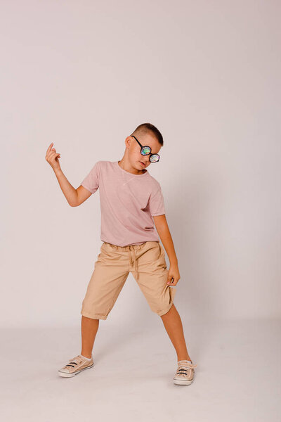 a boy dancing in disco glasses on a white background
