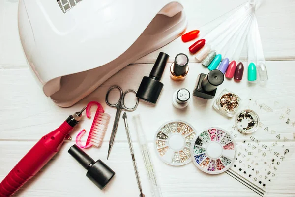 Beyaz ahşap arka planda jöle ve aksesuarlı çivi lambası.