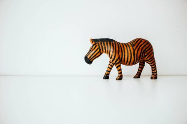 Wooden zebra on a white background. Copy space. Clean background. Wood figure.