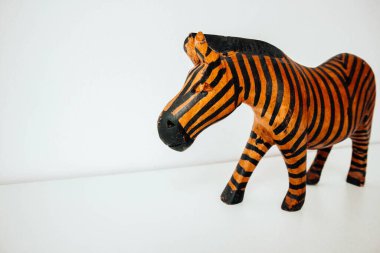Wooden zebra on a white background. Copy space. Clean background. Wood figure.