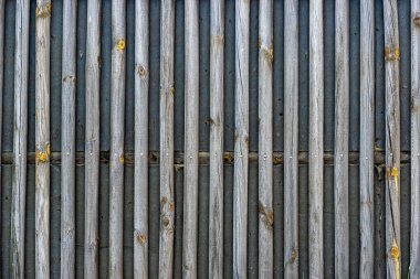 Fence made of battens, with larger gaps older but preserved. Texture or background