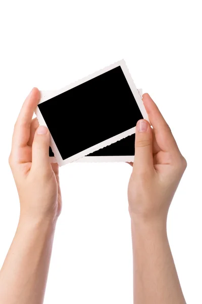 Mãos segurando uma fotografia isolada em um fundo branco — Fotografia de Stock