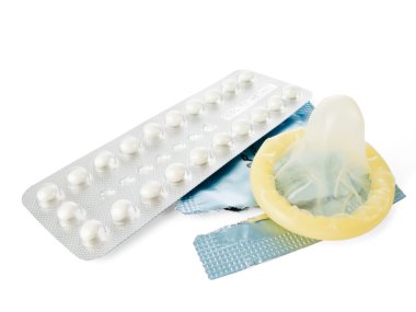 Birth Control Pills and a Condom isolated on white clipart