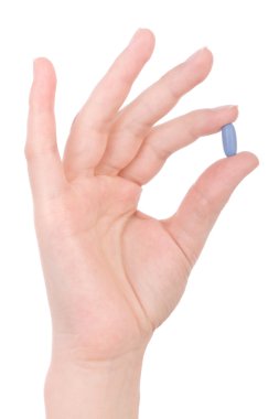 Hand holding a blue pill isolated on white clipart