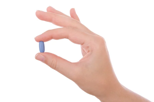 Hand holding a blue pill isolated on white — Stock Photo, Image