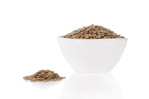 Brown lentils in a bowl isolated on a white background — Stock Photo, Image
