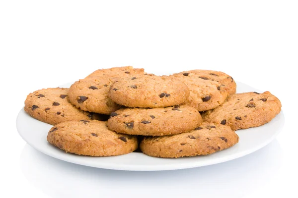 Pile of chocolate chip cookies on a dish isolated on white background — Stock Photo, Image