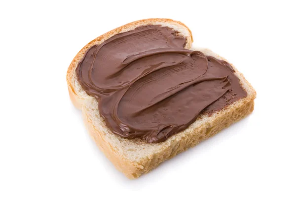 Hazelnut and chocolate spread over a slice of bread — Stock Photo, Image