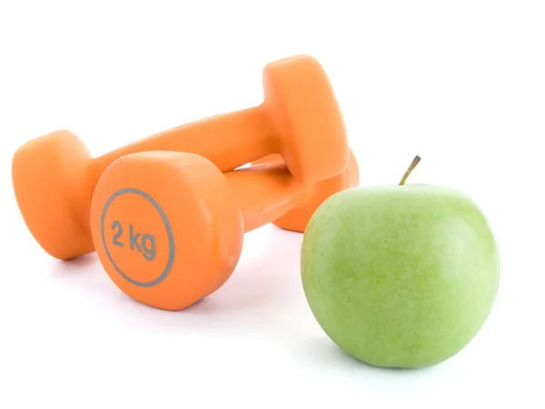 Fitness dumbbells and an apple — Stock Photo, Image