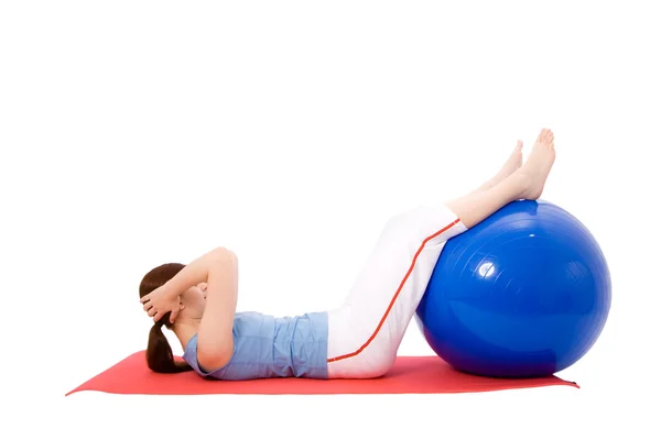 Young woman performing fitness exercises with a fitness ball — Stock Photo, Image