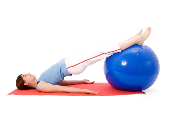 Young woman performing fitness exercises with a fitness ball — Stock Photo, Image