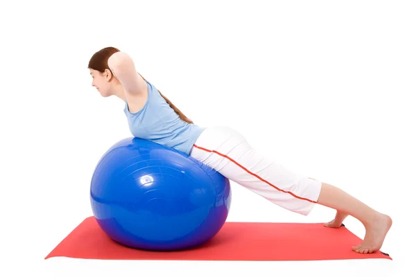 Young woman performing fitness exercises with a fitness ball — Stock Photo, Image