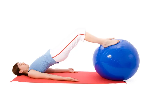 Young woman performing fitness exercises with a fitness ball — Stock Photo, Image