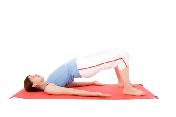 Young woman performing fitness exercises in the ground — Stock Photo, Image