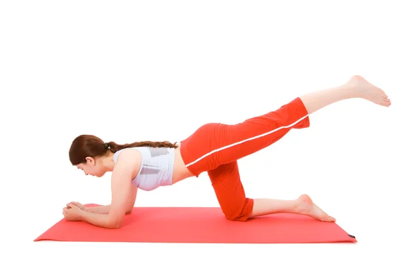 Young woman performing fitness exercises on the ground — Stock Photo, Image