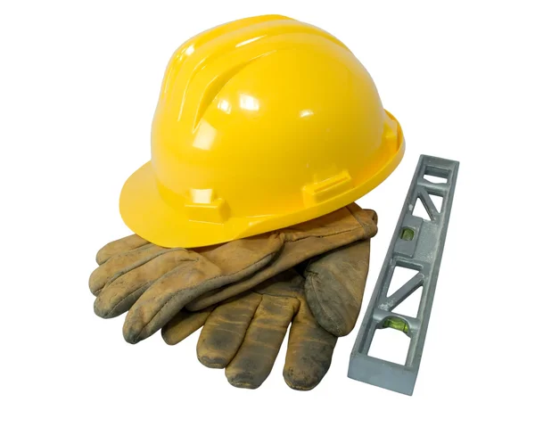 Żółty kask, stare skórzane rękawiczki i poziom na białym tle — Zdjęcie stockowe