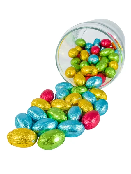 Chocolate eggs spilling out of a jar. Traditional Easter sweet. — Stock Photo, Image