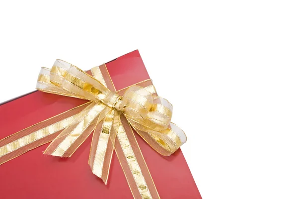 Red gift with a golden bow isolated on white background — Stock Photo, Image