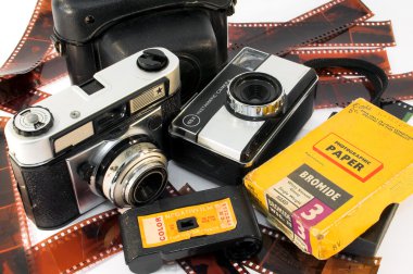 Old, vintage film cameras with photo paper, negative roll and case