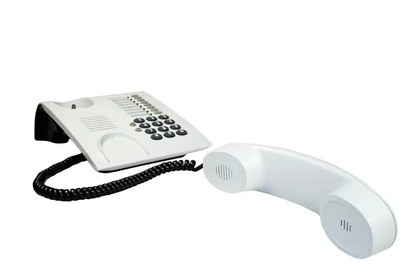 Office telephone with sinuous cord isolated on white. — Stockfoto