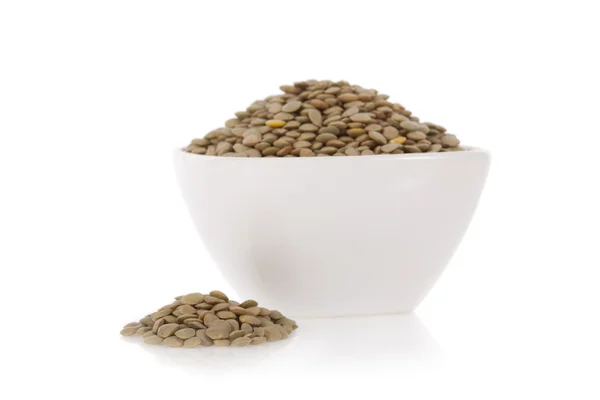 Brown lentils in a bowl isolated on a white background — Stock Photo, Image