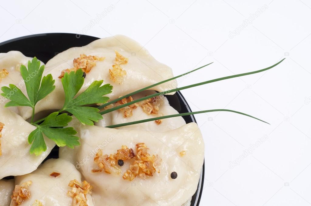 Dumplings with fried onion and herbs.