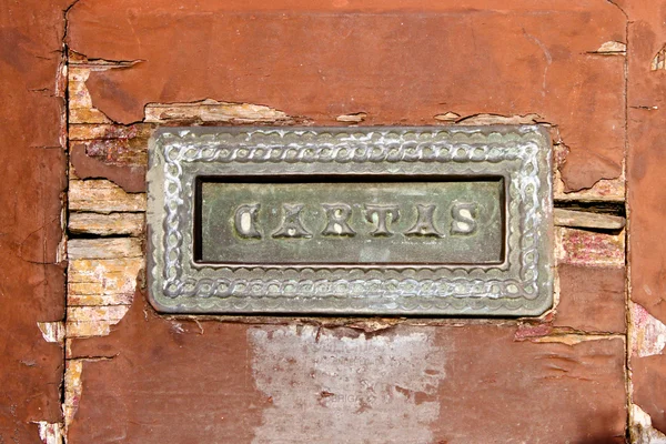 Old mail slot in a wooden door — Stock Photo, Image