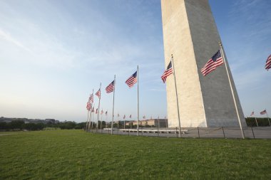 Wide angle view base of Washington Monument with flags clipart