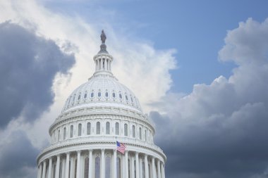 US Capitol dome under stormy skies clipart