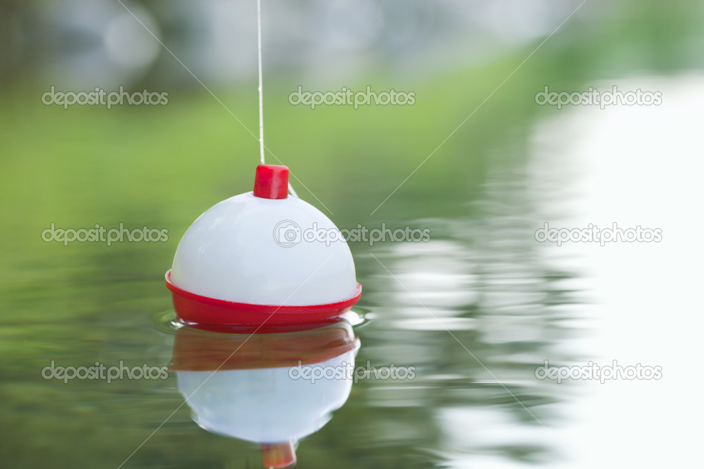 Bobber floating in on water with ripples