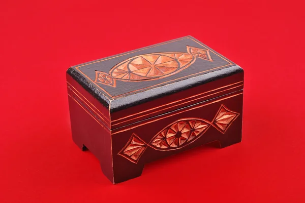 Wooden treasure chest on red — Stock Photo, Image