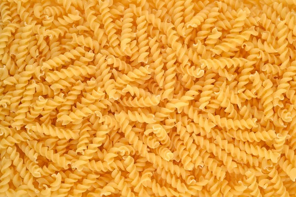 Italiaanse pasta fusilli achtergrond. — Stockfoto