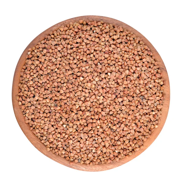 Raw buckwheat in a wooden bowl on a white background — Stock Photo, Image