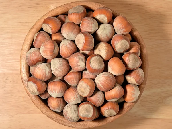 Hazelnuts in a wooden bowl — Stock Photo, Image