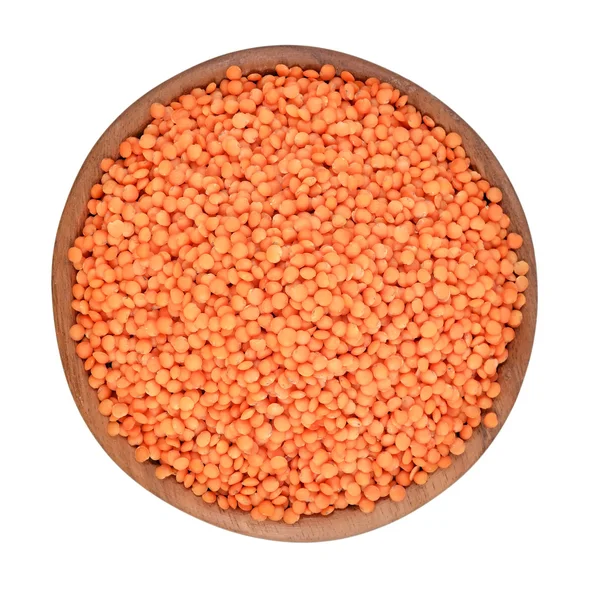Red raw lentil in a wooden bowl on a white background — Stock Photo, Image