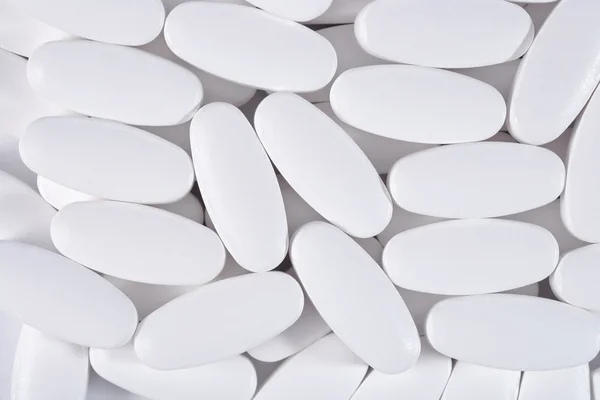 Pílulas brancas fundo — Fotografia de Stock