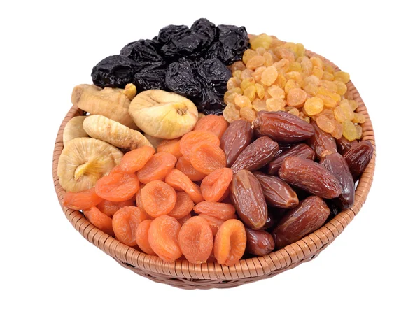 Various dried fruits in wicker bowl — Stock Photo, Image