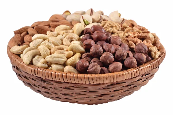 Assorted nuts in a wicker bowl on a white background — Stock Photo, Image