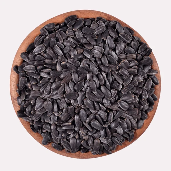 Czarne nasiona słonecznika w misce drewniane — Zdjęcie stockowe