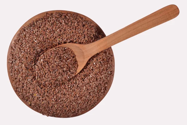 Linseed in a wooden bowl on a white — Stock Photo, Image