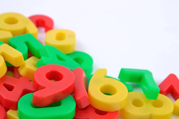 Colorful plastic numbers on white — Stock Photo, Image