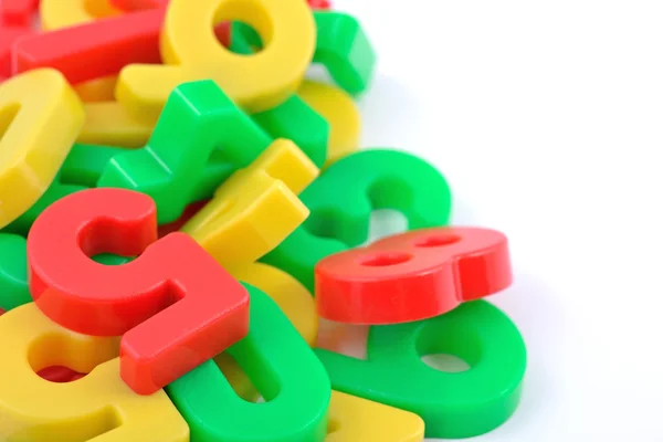 Colorful plastic numbers on white — Stock Photo, Image