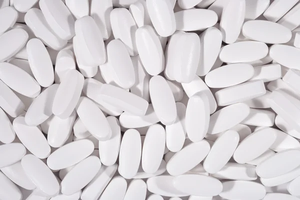 Pílulas brancas fundo — Fotografia de Stock