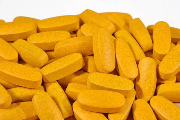 Heap of yellow pills — Stock Photo, Image