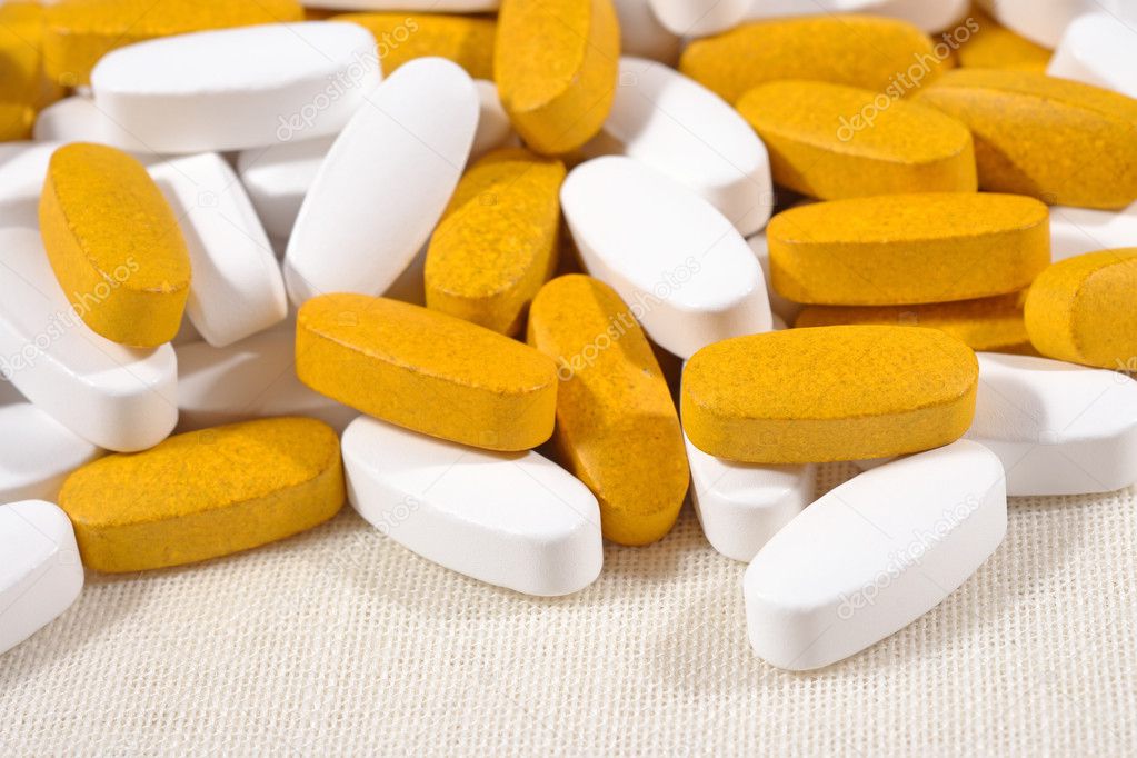 Heap of white and yellow pills